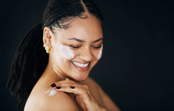 istock Happy Woman Applying Face Cream in Skincare Routine 2174876362