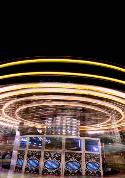 istock 'Witney Feast' Travelling Fairground Ride - 'Galloping Majors' Light Trail 2174877188