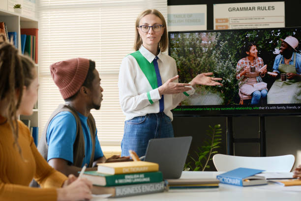 istock Female Teacher Showing Video on Screen to Students 2174878307