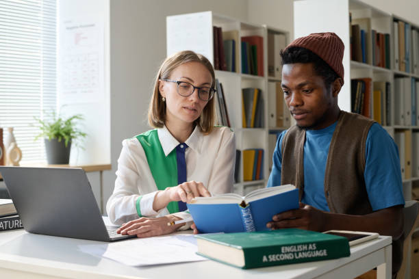 Student with Teacher during Personal Lesson in School or College