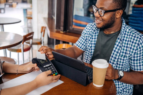 istock Asian waitress working at cafe holding credit card reader in front of regular customer 2174878612