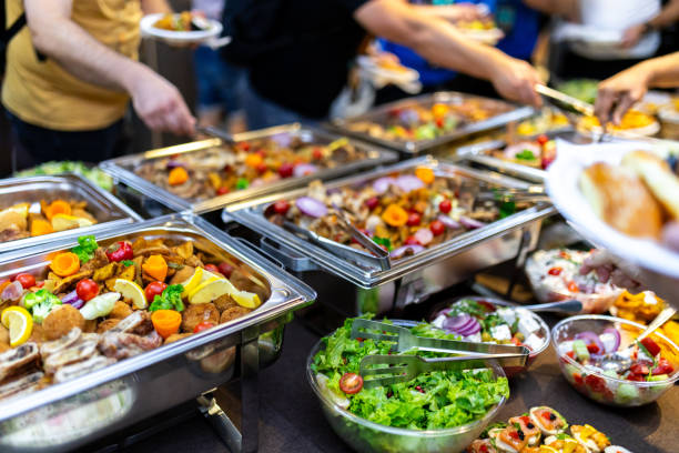 istock Buffet-style feast featuring diverse dishes and fresh salads at a lively community gathering in the evening 2174879913