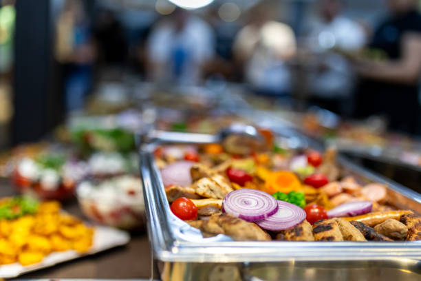 istock A vibrant buffet featuring grilled chicken, fresh vegetables, and colorful garnishes at an indoor gathering during a festive celebration 2174882209