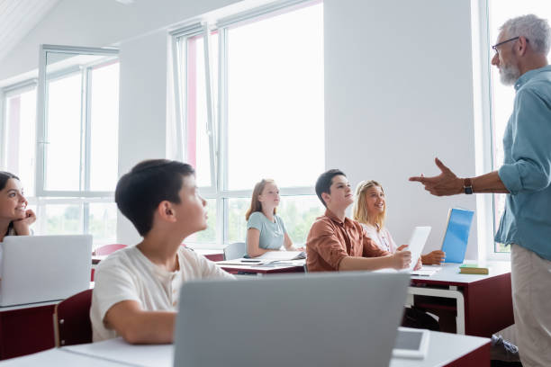 istock Engaged teens learning in a modern classroom during an interactive lesson with their mentor 2174883346