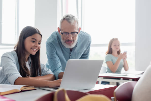 istock Engaging classroom moment with teens collaborating on a project during a technology lesson 2174883351
