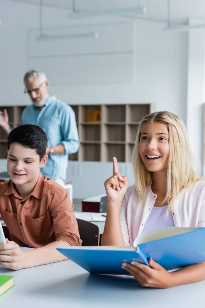 istock Engaged teens sharing ideas during a lively classroom discussion at their school 2174883405