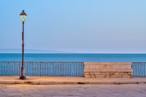 istock Street light and an empty bench at dawn 2174883449