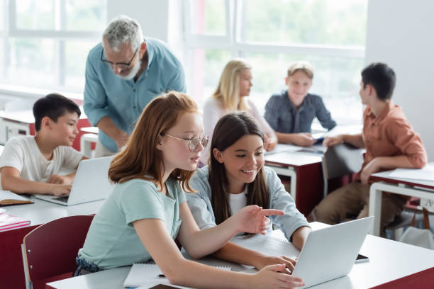 istock Engaged teens collaborate on school projects in a vibrant classroom filled with technology 2174883489