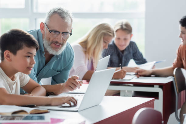 istock Teen students engaged in collaborative learning with a teacher in a bright classroom environment 2174883513