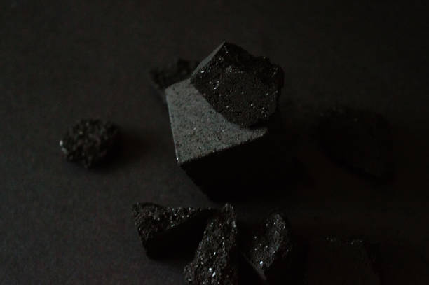 istock A pile of charcoal cubes for hookah on a black background. Damage coal cube. Space for text. Soft focus. Photo for your brand designs and advertisement. 2174883669