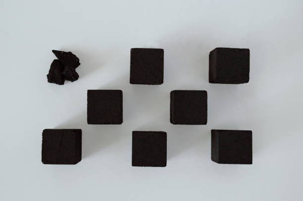 istock Charcoal cubes chess composition on a white background. Coal cubes for hookah. Photo for your brand designs and advertisement. 2174883795