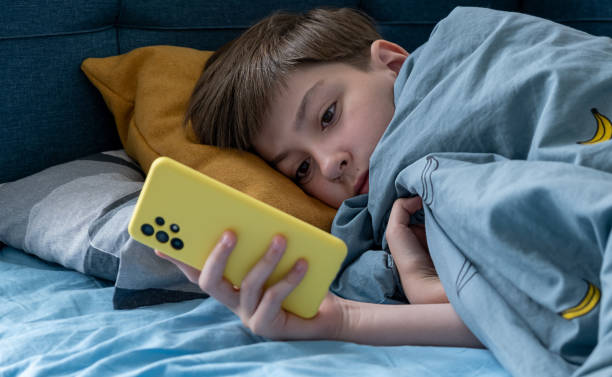 istock Boy using mobile phone in bed in the dark, social concept 2174884218