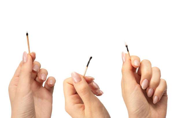 istock Lit match in a woman hand isolated on a white background. 2174884305