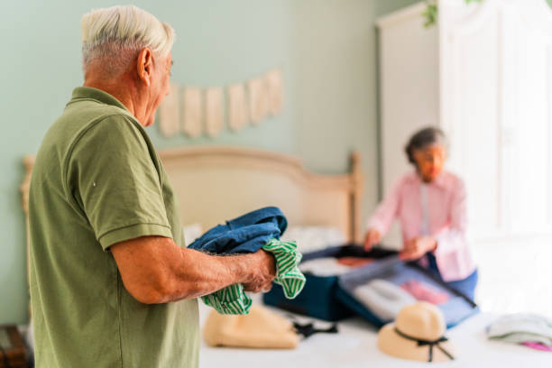 istock Senior man packing suitcase at home 2174884356