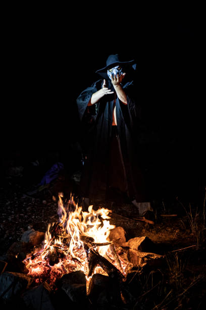 Man in Mask Ceremonial Dancing Around a Fire.