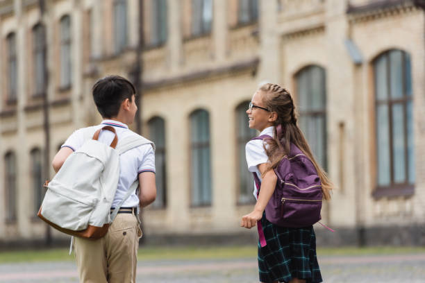 istock Joyful kids exploring outdoors after school with backpacks on a sunny day 2174884837