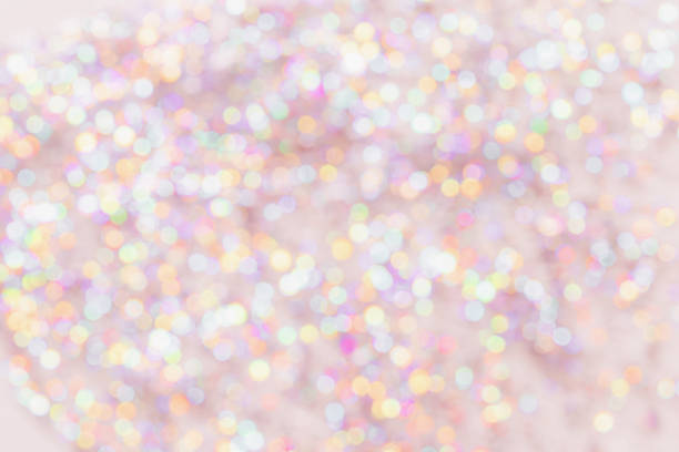 Defocused abstract bokeh background pastel colored, flare from lights, color gradient, blurred circle bokeh as holiday texture. Glittering aesthetic textured lighting pattern