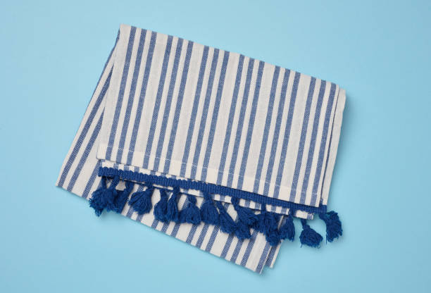 istock Folded linen striped kitchen towel on blue background, top view 2174886477