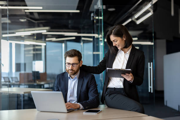 istock Professional business colleagues in modern office working on laptop and digital tablet 2174888013