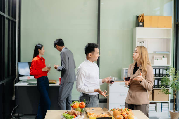 istock Young Asian Professionals Celebrating with Pizza and Drinks in a Modern Office Setting 2174890735