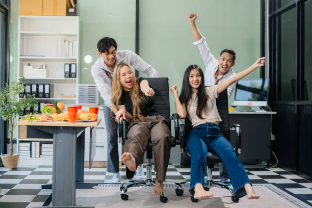 istock Young Asian Professionals Celebrating with Pizza and Drinks in a Modern Office Setting 2174890752