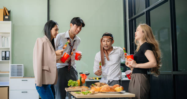 istock Young Asian Professionals Celebrating with Pizza and Drinks in a Modern Office Setting 2174890772