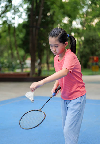 Little girl play badminton