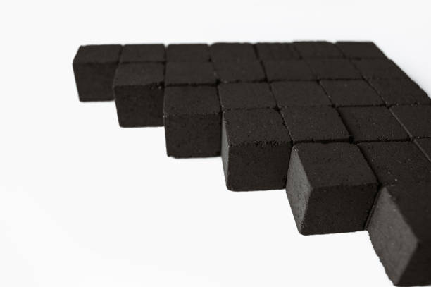 istock Charcoal cubes composition on a white background. Coal cubes for hookah. Photo for your brand designs and advertisement. 2174897105