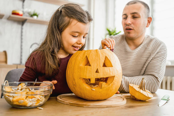 istock Father and daughter making Halloween decorations 2174897500