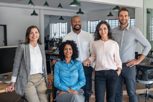 istock Smiling group of diverse businesspeople working in an office 2174898510