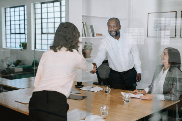 istock Smiling manager shaking hands with a colleague in an office 2174899587