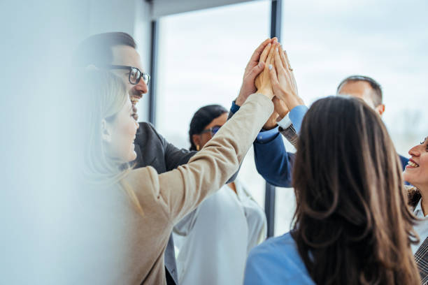 istock Team Celebrating Success with High Five in Office Environment 2174899667