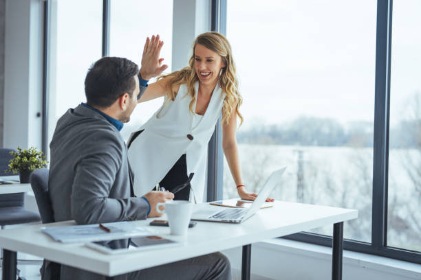 istock Successful Business Team High-Fiving in Modern Office 2174899743