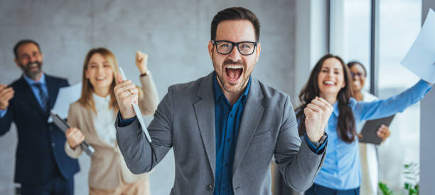 istock Business team celebrating a triumph with arms up. 2174899839