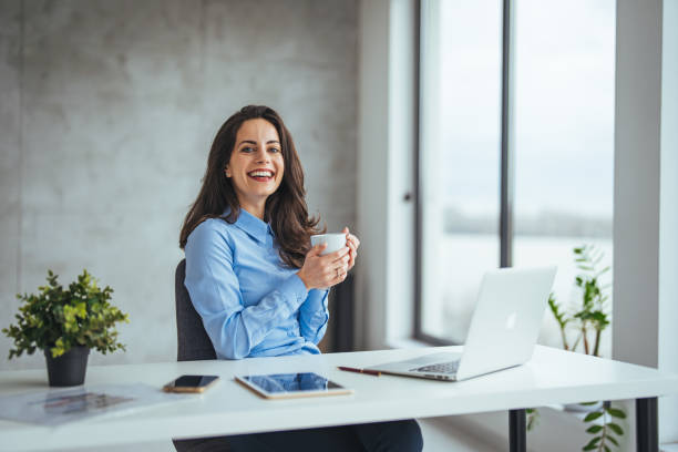 istock An attractive young businesswoman having coffee while working at her office desk. 2174899863