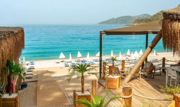 istock Beach View with Sun Loungers and Bars Along the Shoreline 2174900563