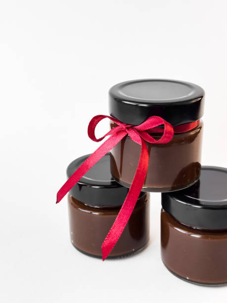 istock Luxurious chocolate spread jars with red ribbon tied for gift giving elegance 2174901005