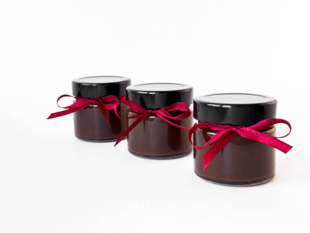 istock Gourmet chocolate jars with red ribbons on white background 2174901079