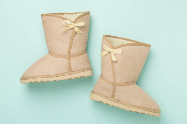 Beautiful woman boots on color background,top view