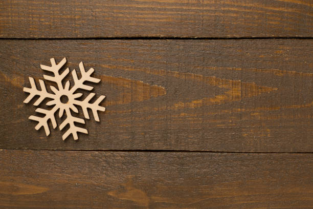 istock Beautiful snowflake on wooden background, top view 2174901568