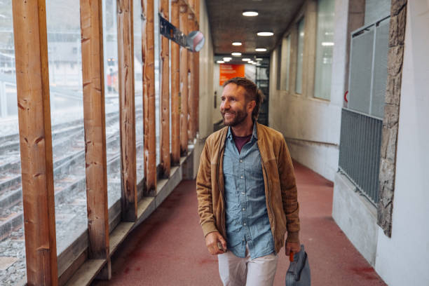 istock A millennial male walks up a corridor in a train station 2174903269