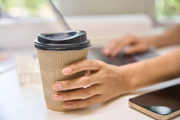 istock Freelancer holds a glass of coffee 2174903490