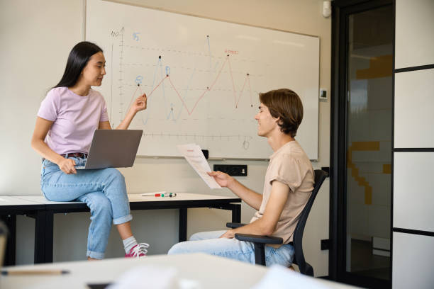 istock Asian female sitting on office desk 2174904193