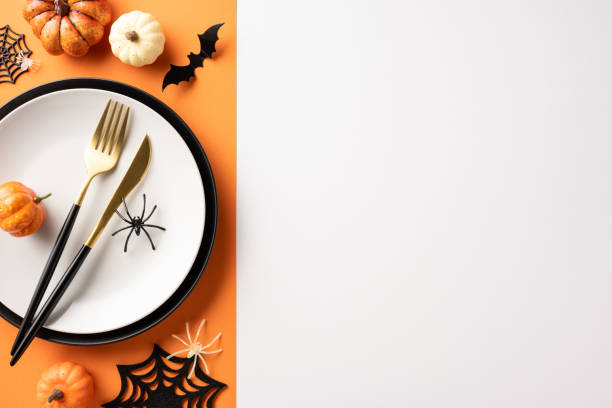 istock Halloween themed dinner table setting with pumpkins, spider decorations, and tableware in a festive arrangement 2174905543