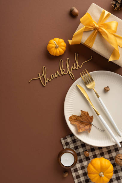 istock Elegant vertical Thanksgiving table setting featuring pumpkins, gift box with yellow ribbon, and autumn decor conveying a warm and thankful atmosphere 2174905648