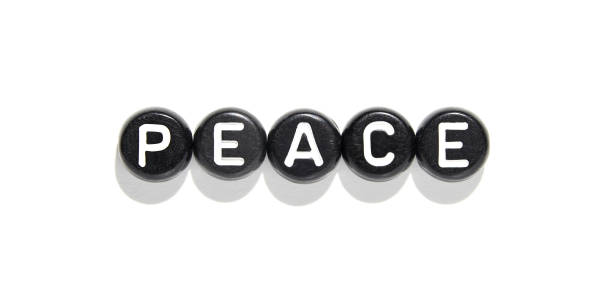 istock Black round beads with white letters spelling peace on white background 2174908281