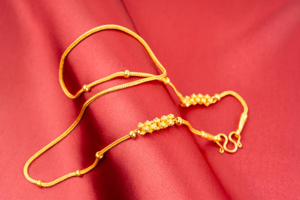 istock A Gold Necklace on red silk background. 2174910051
