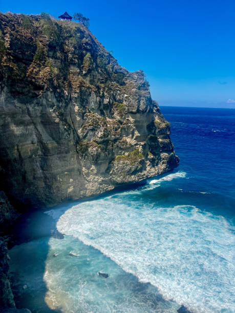 istock A cliff and crystal clear ocean with waves 2174910053