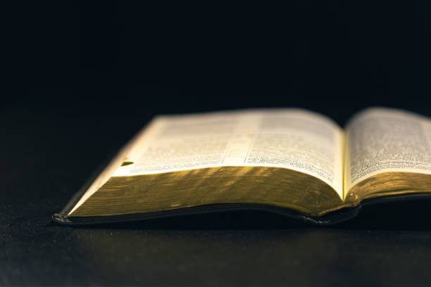 istock Open Bible on a black background. Religion concept. 2174913997