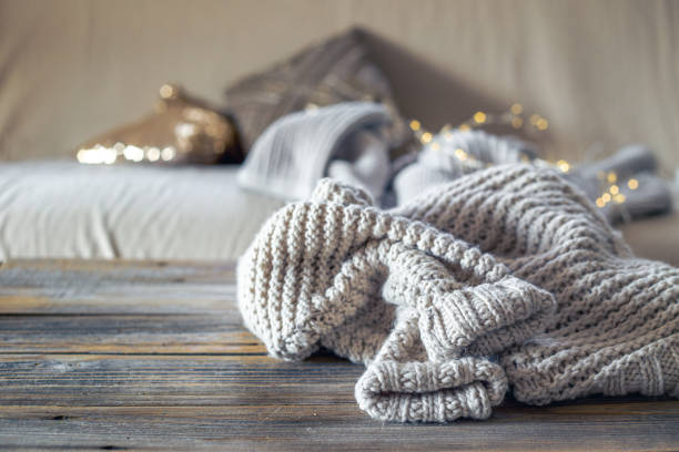 istock Warm winter sweater on a wooden table. Christmas concept. 2174917110